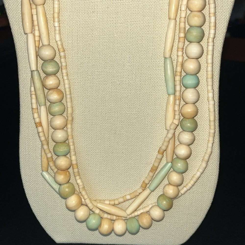 Unique multi-strand light toned beaded long necklace.